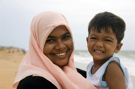Mother wearing hijab holding son